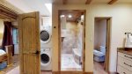 Master bathroom with washer and dryer and walk in shower 